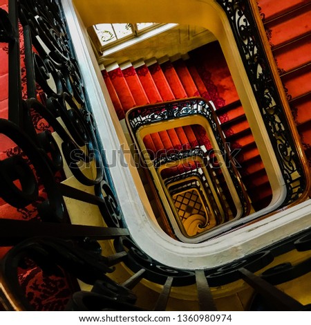 View bottom up on beautiful luxury staircase with wooden railings. Photo consists of staircase with steps for legs people. Steps in staircase are intended to quick pass through floors of building.