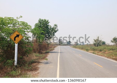 Curved Road Traffic Sign on the road at country side