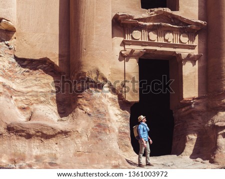 Fashionable tourist, exploring the sights of the ancient, fabulous city of Petra in Jordan. Colorful photos. Concept of leisure, vacation and travel
