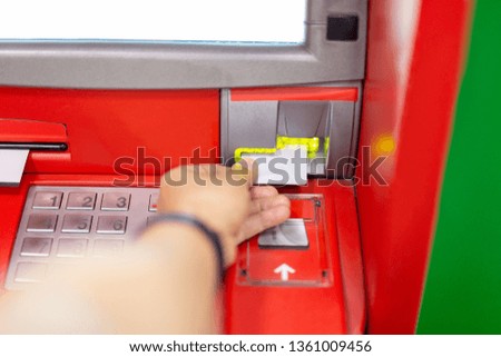 Hand of man using an ATM machine with credit card.