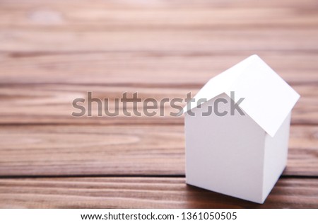 Concept of house in paper on wood. Horizontal composition. Top view.