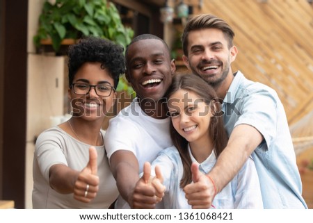 Happy multi ethnic friends group showing thumbs up, smiling diverse young people looking at camera with like gesture recommend good quality racial diversity equality, multiracial friendship, portrait Royalty-Free Stock Photo #1361068421