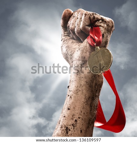 hand holding a winner's medal, success in competitions Royalty-Free Stock Photo #136109597