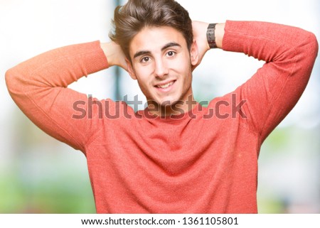 Young handsome man over isolated background Relaxing and stretching with arms and hands behind head and neck, smiling happy