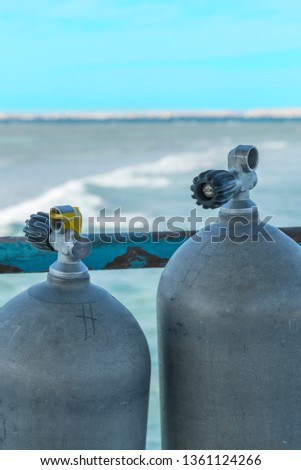 A lot of diving cylinders. oxygen cylinders outdoor. Oxygen cylinders for swimming in the background of the sea. vertical photo