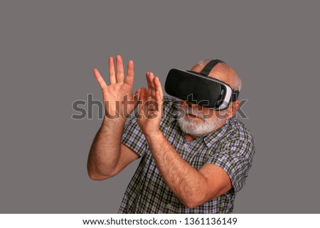 Man wearing virtual reality goggles. Studio shot.