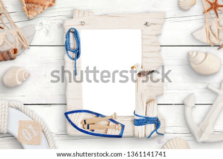 Summer travel photo family isolated frame for mockup surrounded with shells on white wooden table.