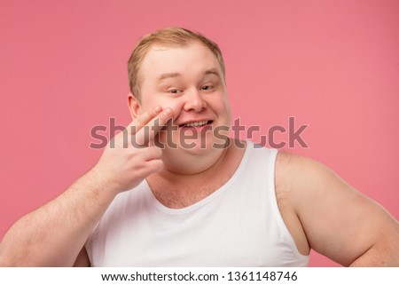 Shaving casual man in underwear, holding razor with happy satisfied emotions isolated over pink background. Skincare goods for sensitive skin concept.