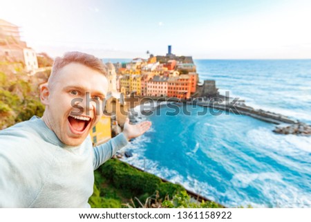 Tourist happy young man taking selfie photo Vernazza, national park Cinque Terre, Liguria, Italy, Europe. Concept travel.
