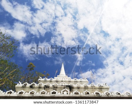 Ancient white pagoda on a blue sky background