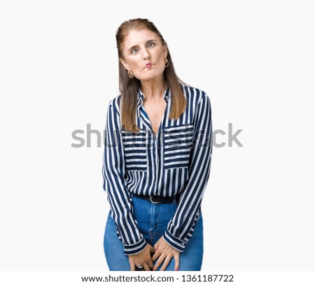 Middle age mature business woman over isolated background making fish face with lips, crazy and comical gesture. Funny expression.