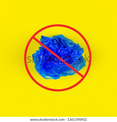 a blue plastic bag on yellow background with a red forbidden sign on top. the concept of the problem to ban the use of plastic bags and containers and environment pollution