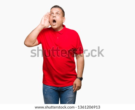 Middle age arab man over isolated background shouting and screaming loud to side with hand on mouth. Communication concept.
