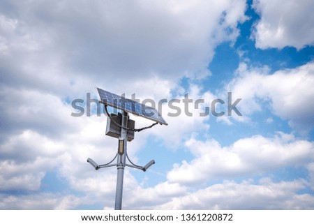 Sunlight collector street lamp and blue sky background. Alternative energy concept. 