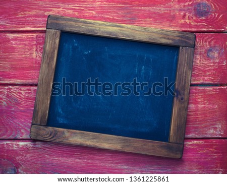 Aged wooden blackboard on rustic background