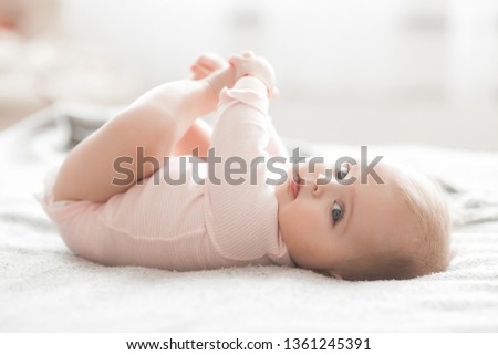 Adorable little baby portrait. Cute baby girl indoor. 6 month child smiling. Royalty-Free Stock Photo #1361245391