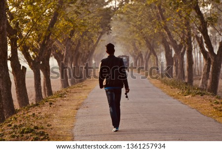 Young man wearing black leather jacket walking on an urban street