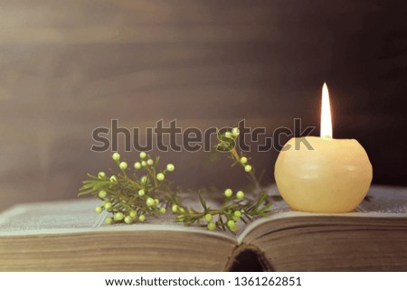Candle, book and flowers   