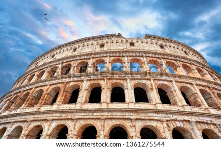 Colosseum (Coliseum or Colosseo) in Rome, Italy. Ancient ruins of Flavian Amphitheatre. Arena for gladiator fightings. World famous landmark and very popular touristic destination for vacation trip. Royalty-Free Stock Photo #1361275544