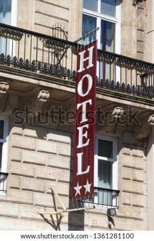 Hotel sign road at the entrance of cozy accommodation in European city 
