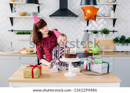 Portrait of happy mother and baby at birthday party