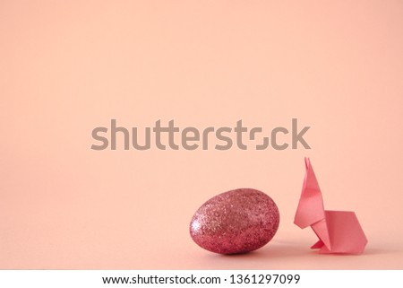 Creative origami paper easter bunny with egg, copy space