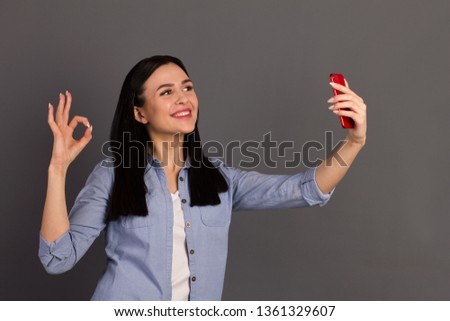 Closeup photo portrait of cheerful excited lovely carefree with teeth toothy beaming smile make take selfie on bright camera device gadget isolated grey background