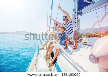 Happy family with adorable daughter and son resting on a big yacht Royalty-Free Stock Photo #1361350232