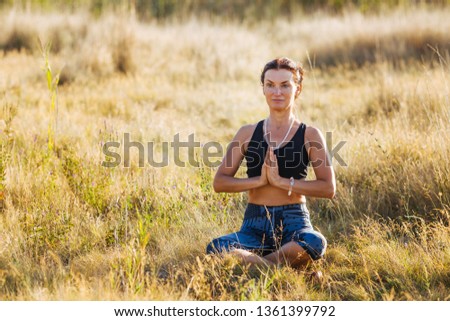 Beautiful woman practicing lotus pose one summer morning. Healthy Concept.
