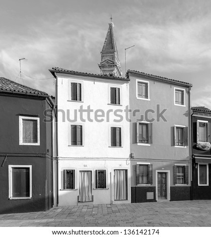 The houses on the shore of the channel near the old leaning Church Tower - Burano, Venice, Italy (black and white)