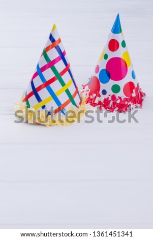 Party hats isolated on white background. Two Birthday paper caps with text space, vertical image. DIY crafts for kids.