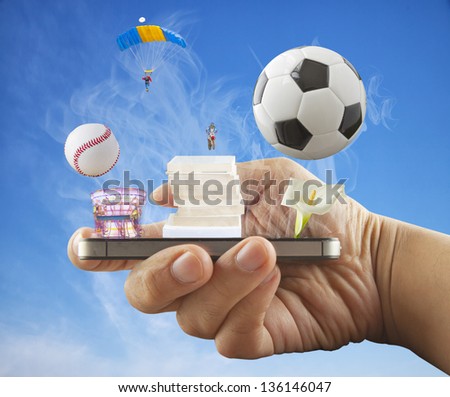 Male hand holding a smartphone, with sports and entertainment objects coming out