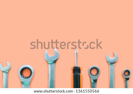 Tools: screwdriver, wrench on an orange background, copy space.Flat lay, top view.  Tools for repair.Male set.