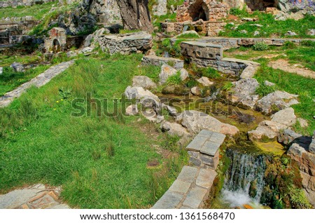 Temple on mountain in city Athens, Hassia Greece, rock fresh water garden