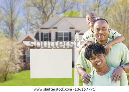 African American Family In Front of Blank Real Estate Sign and New House - Ready for Your Own Text.