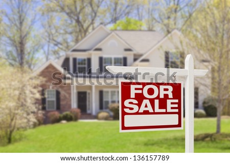 Home For Sale Real Estate Sign and Beautiful New House. Royalty-Free Stock Photo #136157789