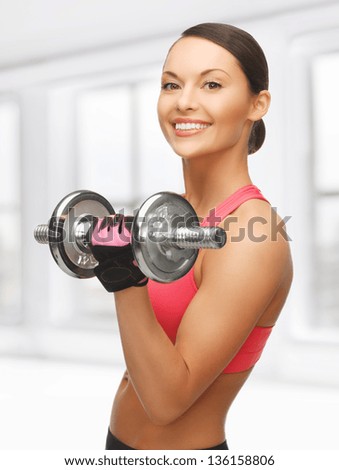 picture of beautiful sporty woman with dumbbell