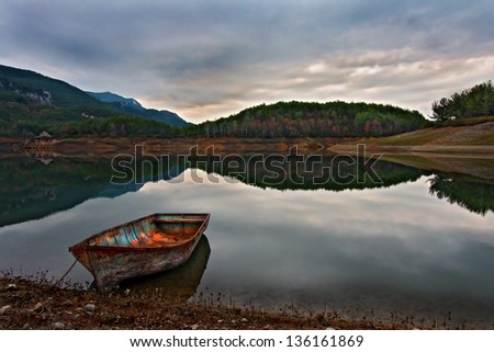 Turkey, Boat tied up on the side of a lake, calm waters