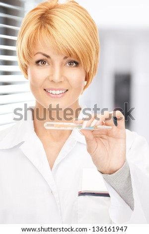 picture of attractive female doctor with thermometer in hospital
