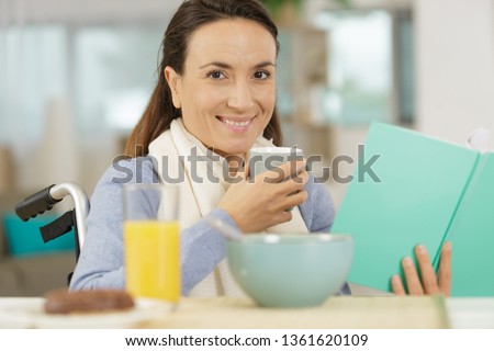 young disabled woman in wheelchair with book