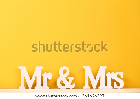White letters Mr and Mrs on yellow background