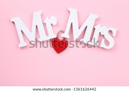 White letters Mr and Mrs with red heart on pink background