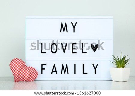 Lightbox with words My Lovely Family on grey background
