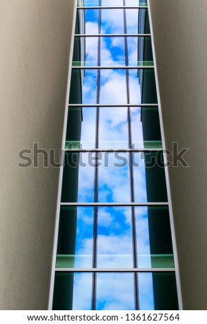 Reflection of the sky in the glass facade of the building.