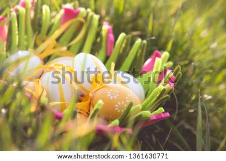 Easter eggs in a basket in the grass