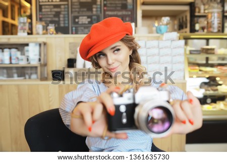 vintage camera girl / beautiful young model holding an old camera in her hands, taking pictures, learning photos