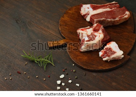 pork ribs on a cutting board on a dark background