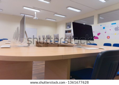 Modern office with computers on desks. Empty computer room in college. Interior of classroom with computers. Concept of corporate working space.