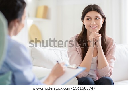 Smiling woman talking to wellness coach about motivation and happiness, free space Royalty-Free Stock Photo #1361685947