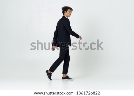Cute elegant man in a black suit office worker